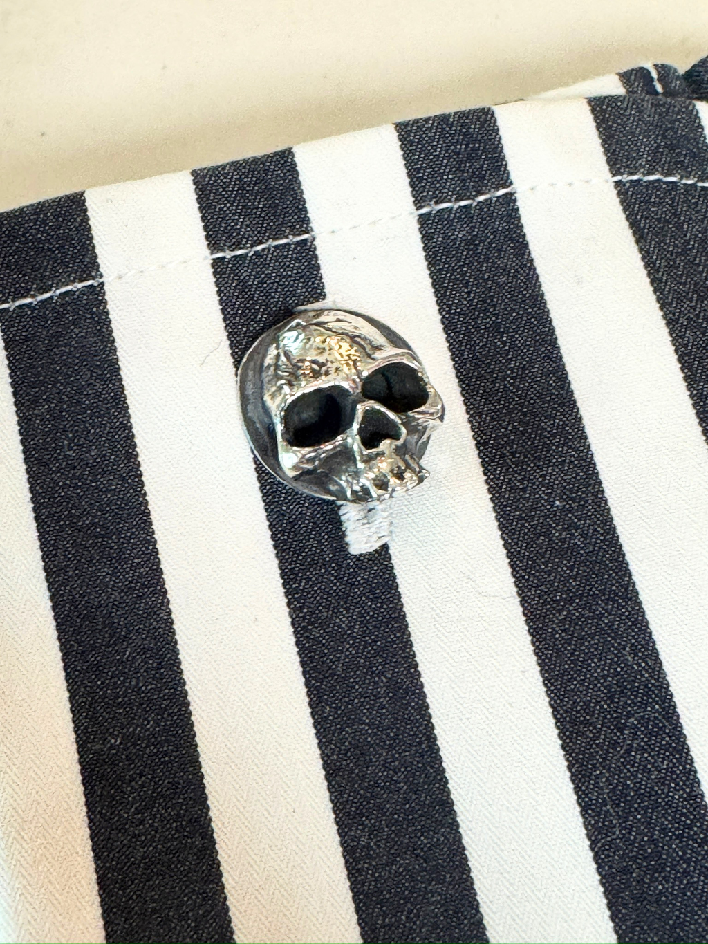 sterling silver skull cufflink on shirt