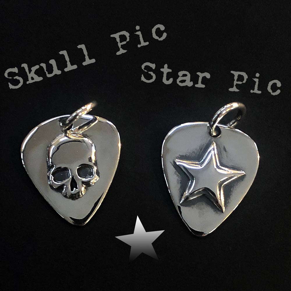 Silver Star Guitar Pic Pendant and skull guitar pic pendant on black.