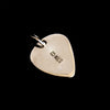 back of a silver guitar pic pendant on black