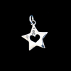 back side of heart cutout of star pendant on black. 