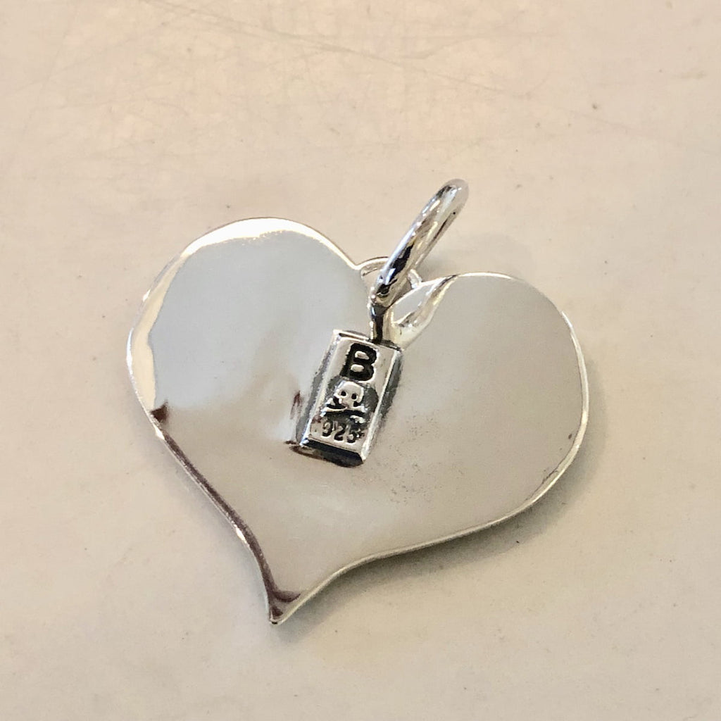True Love Double Skull Pendant shows makers mark on back. 