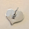 True Love Double Skull Pendant shows makers mark on back. 
