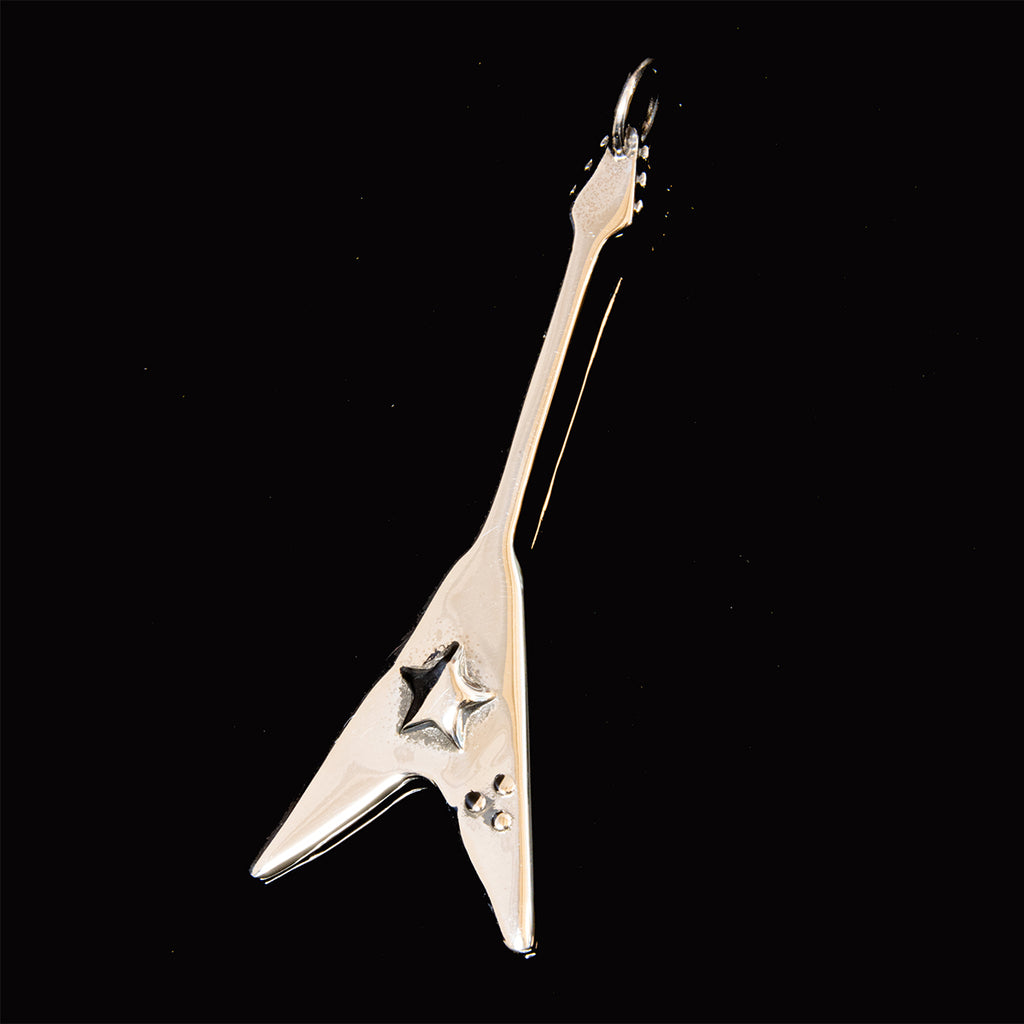 flying v guitar pendant on black. 