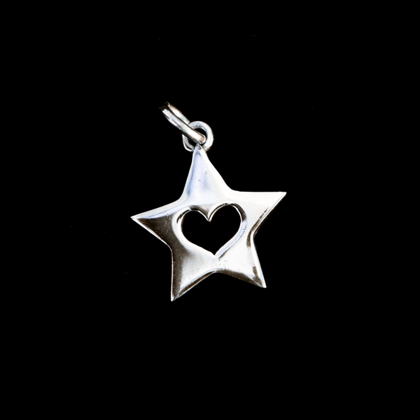 heart inside a star pendant on black. 