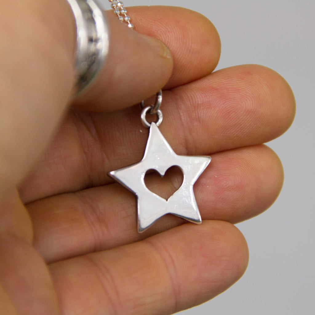 heart in star pendant in hand. 