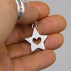 heart in star pendant in hand. 