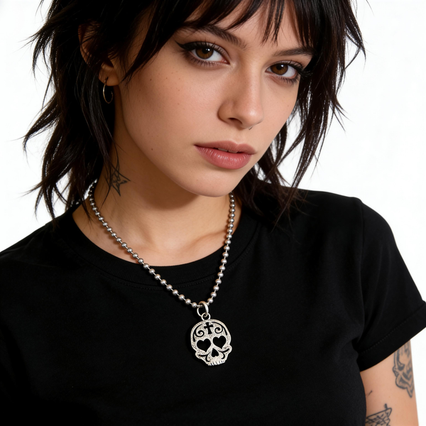 Woman wearing a black t-shirt with a skull pendant necklace on a white background