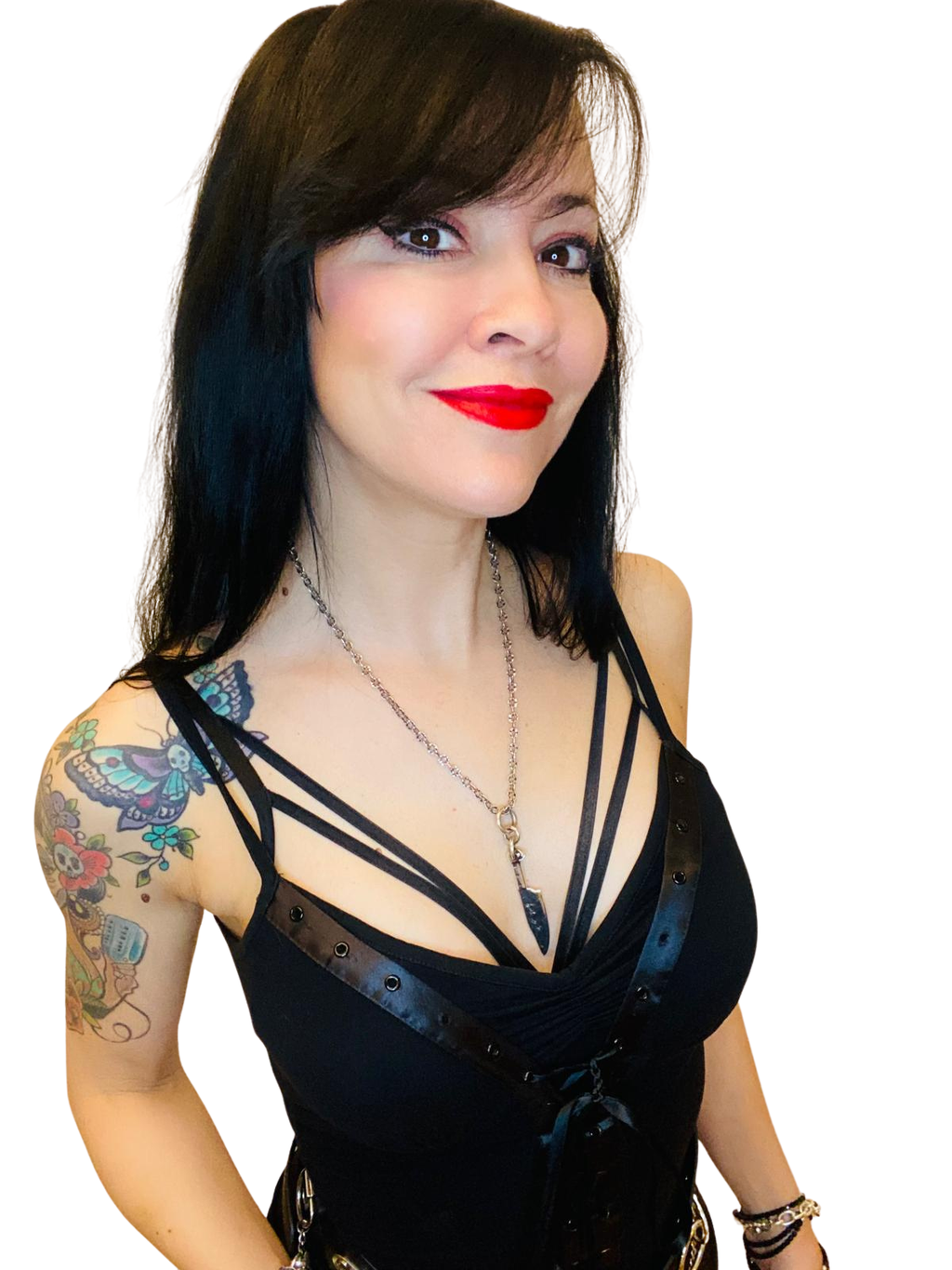 Woman wearing a black strappy top with a knife pendant against a white background
