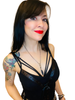 Woman wearing a black strappy top with a knife pendant against a white background
