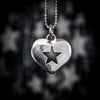 Silver heart-shaped pendant with a star cutout on a blurred starry background