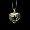 Silver heart-shaped pendant with a star design on a black background