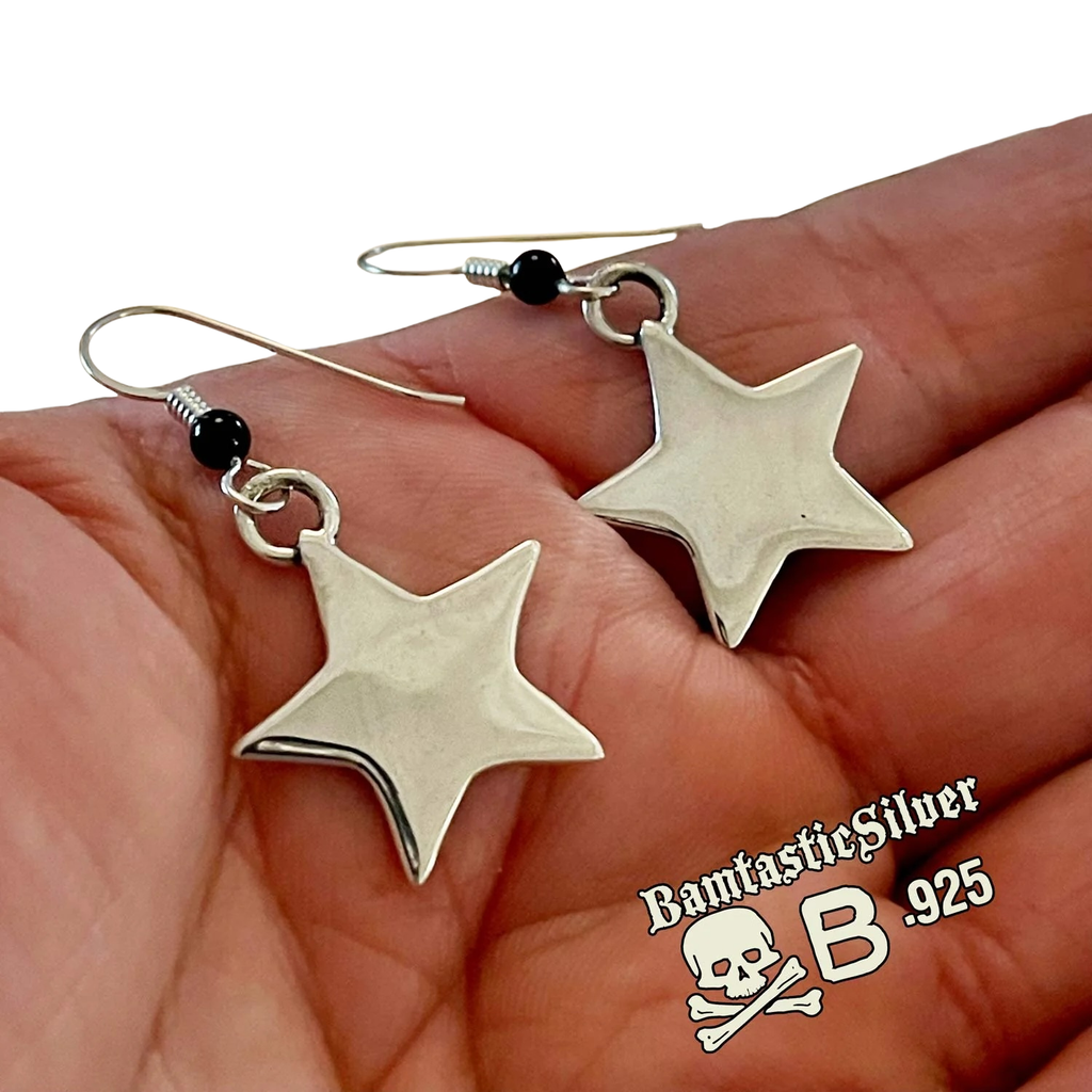 Silver star earrings held in a hand with 'Bantastic Silver' branding.