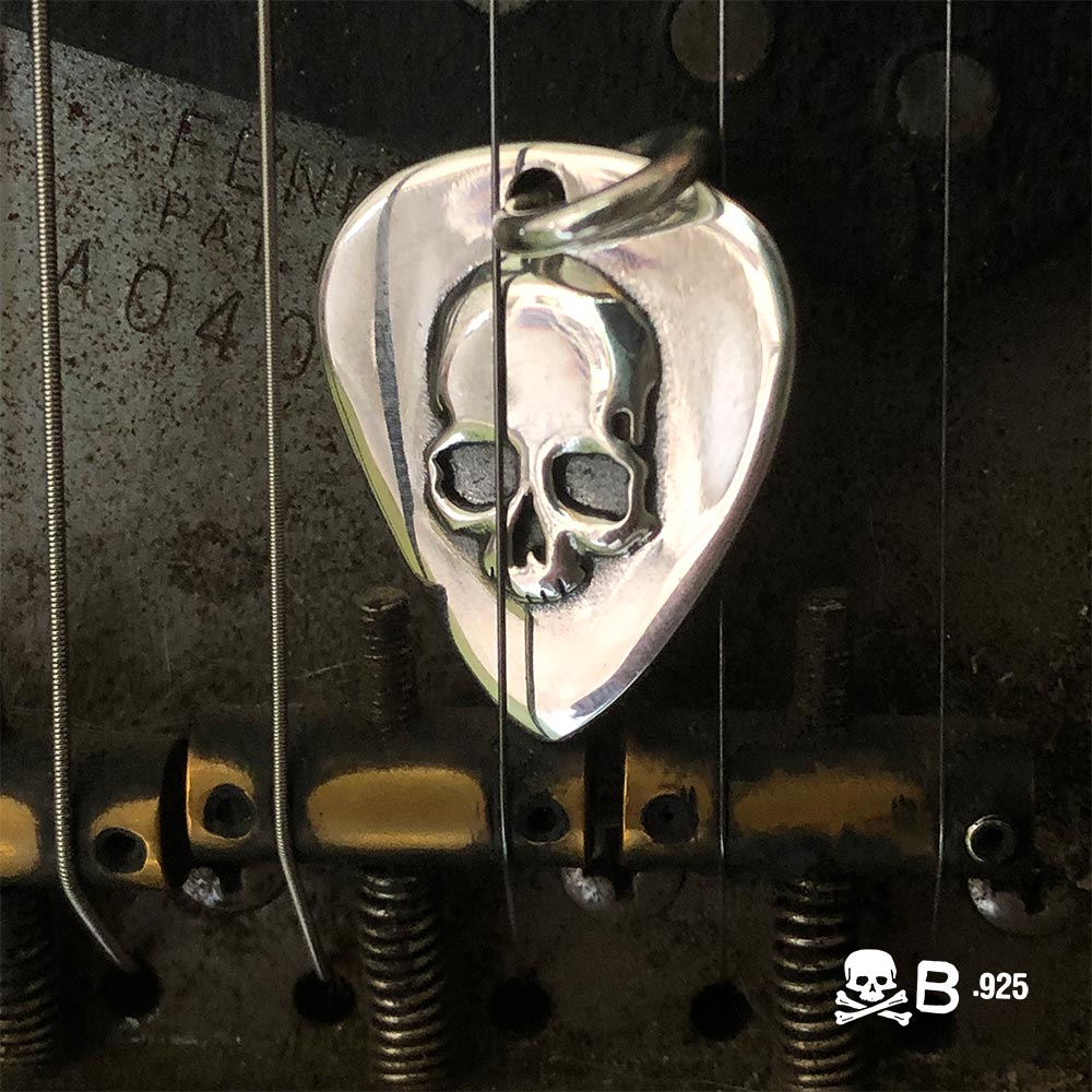Guitar Pic Skull pendant in a fender guitar