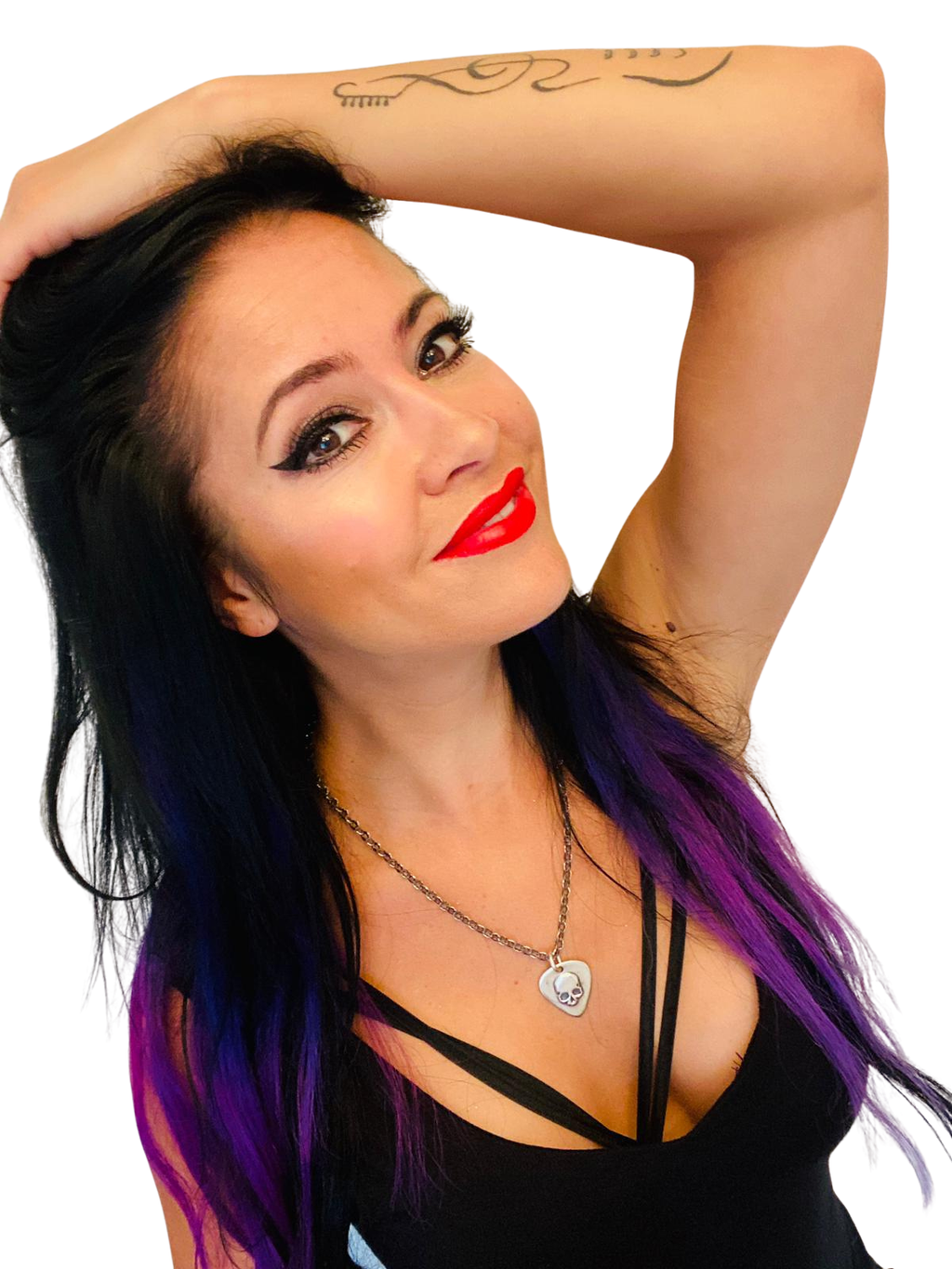 Woman with purple hair and red lipstick wearing a skull guitar pic pendant on white background. 