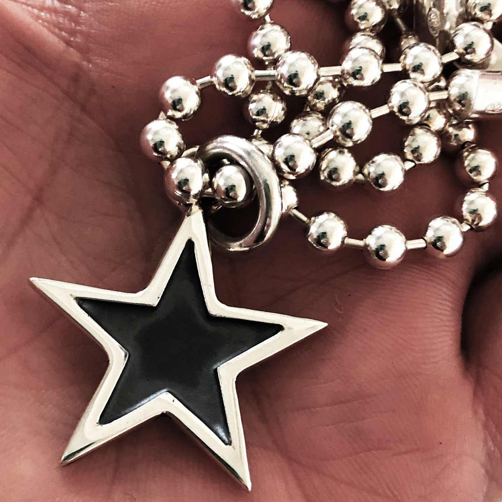 The Star Pendant with chain in hand 