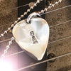 Silver Star Guitar Pic Pendant on a guitar.