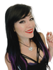 Woman with long black and purple hair wearing a silver heart pendant with skulls on a white background